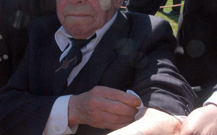 Benjamin Gelhorn shows a tattoo of the number 142906, which was burned into his arm during World War II at the concentration camp in Auschwitz, Poland. Gelhorn was attending a ceremony for the placing of gravestones at Stuttgart Army Airfield in Germany, where the remains of 34 Holocaust victims were found in September 2005.