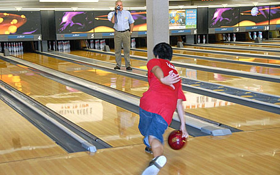 DJ LaMarr practices his strike release during a bowling lesson as his instructor, Ken Miller, video tapes his efforts.