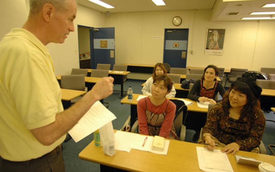 Bob Long, a consultant with Yokosuka Naval Base's Fleet and Family Support Center, gives instruction in the first of a two-part program on teaching English as a second in Japan. Part one covers the basics as well as touches on paying taxes and applicable rules and regulations.