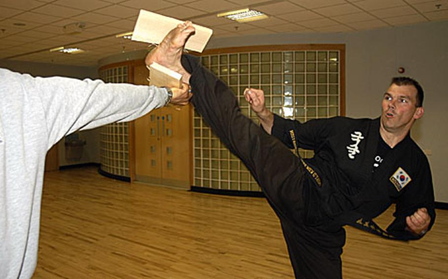 Martial arts expert and Lakenheath Fitness Center instructor Darrin Hart smashes a board in a demonstration of one of the skills he displayed on "Britain's Got Talent," a national talent contest.