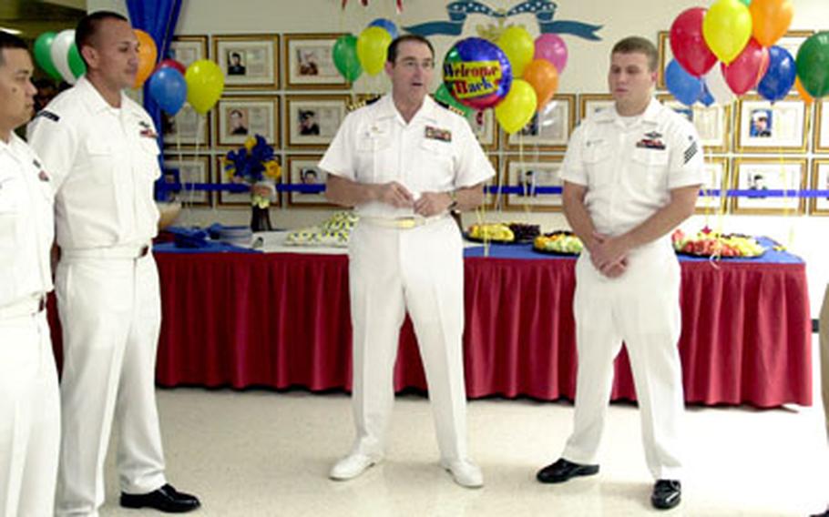 Capt. Peter F. O’Connor, middle, U.S. Naval Hospital Okinawa commander, speaks Tuesday at a welcoming ceremony to honor Seaman John Hammersla, left, Petty Officer 1st Class Thomas Parra, second from left, Seaman Tim Blazosky and Lt. Rachel Snider, who recently returned from deployments to Iraq.