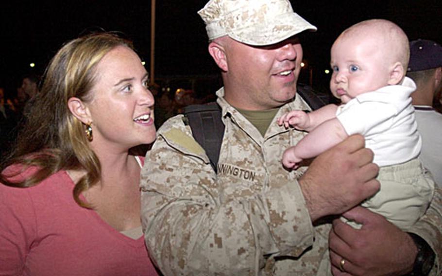 Sgt. David Pennington holds, for the first time, his son David, as his wife Tammy watches. “He’s more beautiful than I thought he would be,” said the sergeant.