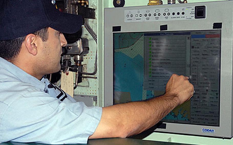 A sailor aboard the USS Oklahoma City familiarizes himself with the Voyage Management System. VMS is a combination of digital charts, constant global positioning system fixes, environmental sensors and electronic command and control to allow the submarine to eliminate many of the constraining aspects of navigation when using paper charts.