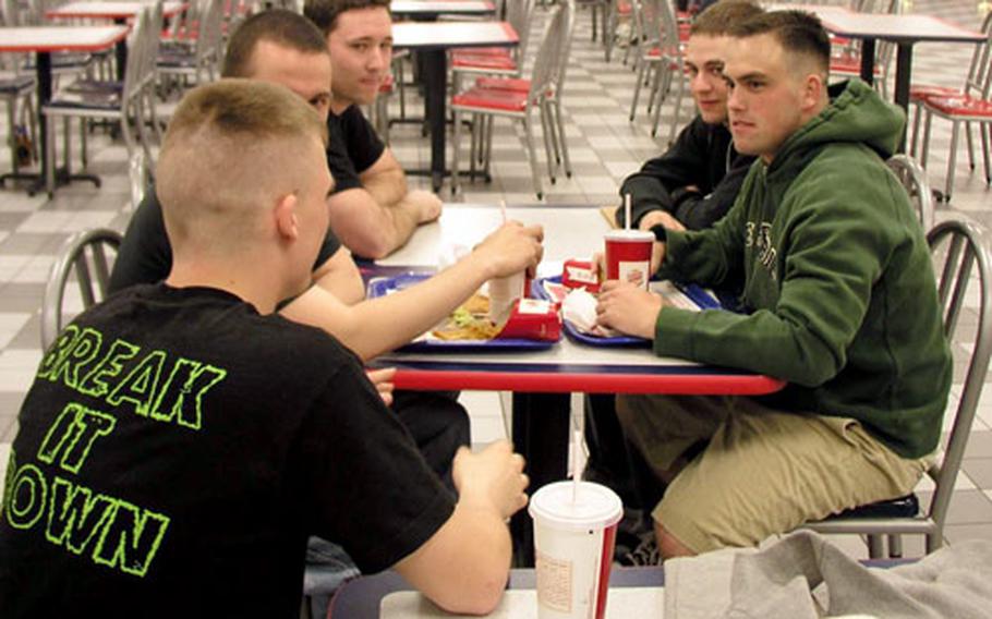 At Kunsan Air Base in South Korea Thursday night, airmen relax with conversation and laughs. Seated, from left, are Airman 1st Class Shawn Cotter, Senior Airman Josh Frazer, Staff Sgt. Theadore McCartha, Airman 1st Class Mathew Bray, and Airman 1st Class Josh Dent, all of the 8th Communications Squadron.