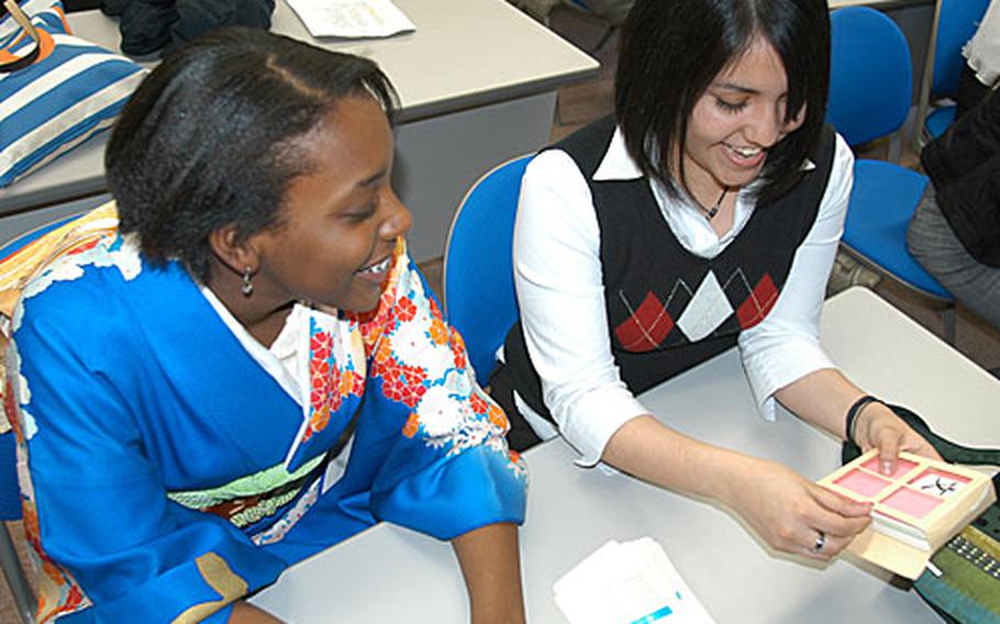 Sophomore Arianna Griffith, left, and junior Vangelina Gonzalez, both of Robert D. Edgren High School at Misawa, review Kanji cards during a break at the 17th annual DODDS Japan Foreign Language Festival. Fifty-nine students from mainland Japan competed in the one-day event at Misawa International Center last week.