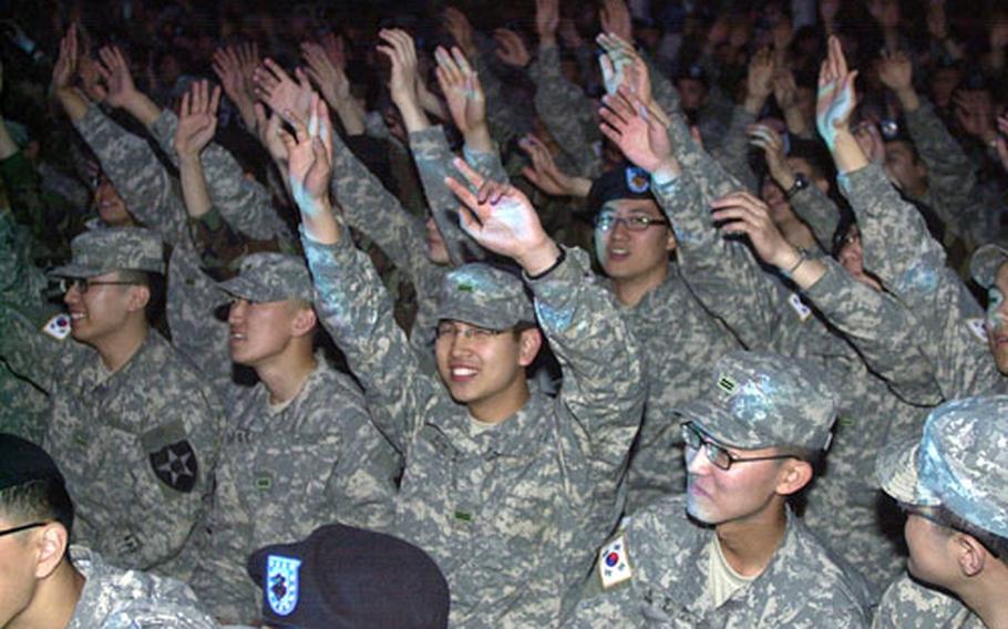 South Korean soldiers sway to the live music at a U.S./KATUSA friendship week concert at the Schoonover Bowl on Camp Casey Thursday night. The concert served to kick-off a Friendship Week that begins Monday in the camps north of Seoul.