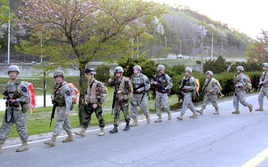 Soldiers from the 2nd Infantry Division set off from the Camp Casey theater parking lot for the “Manchu Mile,” a 25-mile overnight march. The 2nd Battalion, 9th Infantry Regiment’s tradition commemorates a 1900 battle during China’s Boxer Rebellion.