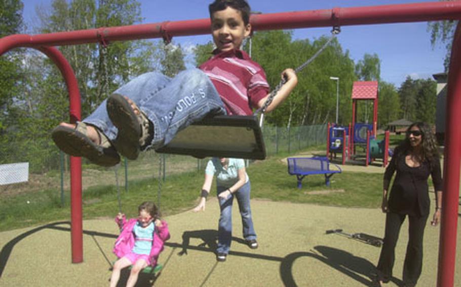 Joey Hermansen, 5, gets a push on a swing at Landstuhl Regional Medical Center from his pregnant mother Salwa, right. Hermansen, whose husband works for the U.S. Embassy in Egypt, traveled to Landstuhl to give birth as part of the Storknest program. To the left is Hermansen's Storknest "buddy" Tawny Campbell and Campbell's 4-year-old daughter, Ceilidhal.
