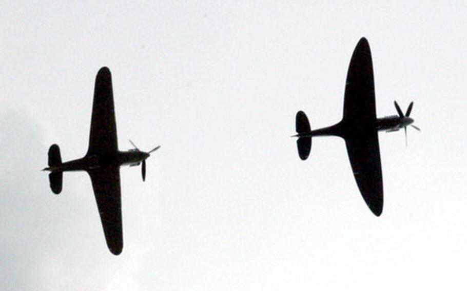 Crowds first heard the drone, then craned their necks as vintage aircraft made repearted flyovers during the celebration.