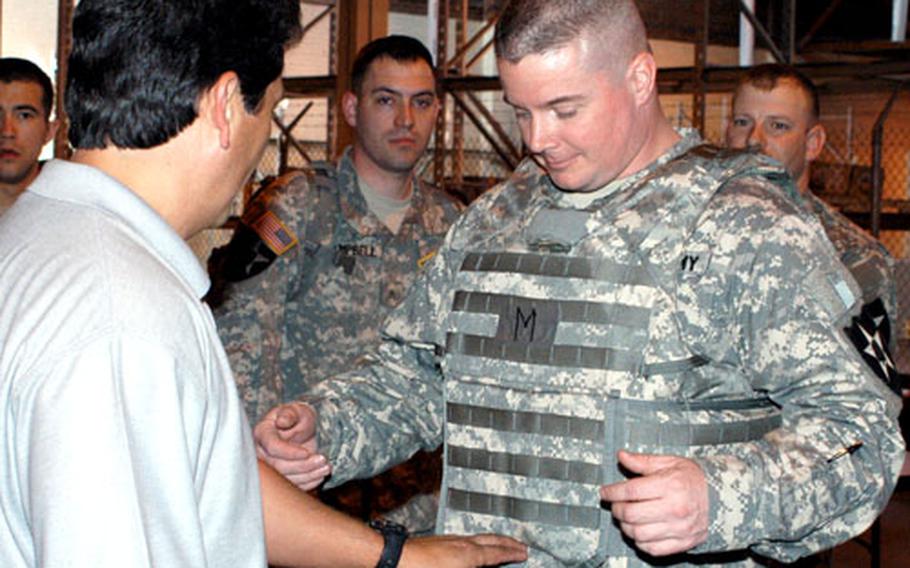 Soldiers with the 4th Battalion, 9th Infantry, which is part of the 4th Stryker Brigade, 2nd Infantry Division at Fort Lewis, Wash., examine the new Improved Outer Tactical Vest. They were the first soldiers to receive the IOTV, according to program managers.