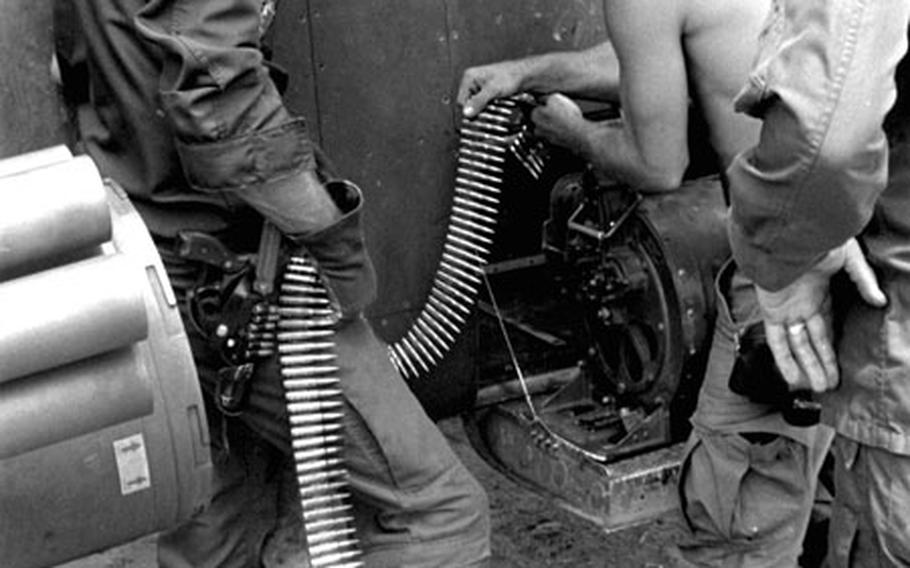 The ground crew loads ammunition onto a Cobra helicopter at Tay Ninh, South Vietnam, in 1971.