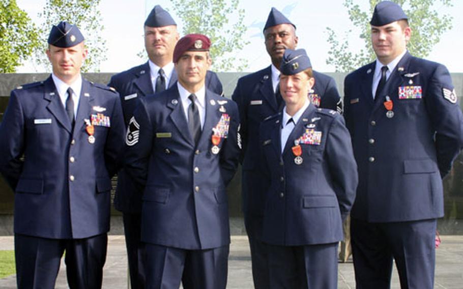 The first six airmen to be presented with the new the Air Force Combat Action Medal are, back row from left, Maj. Steve Raspet, Master Sgt. Byron P. Allen, Master Sgt. Charlie Peterson, and Staff Sgt. Daniel Paxton; and front row, Senior Master Sgt. Ramon Colon-Lopez and Capt. Allison K. Black.