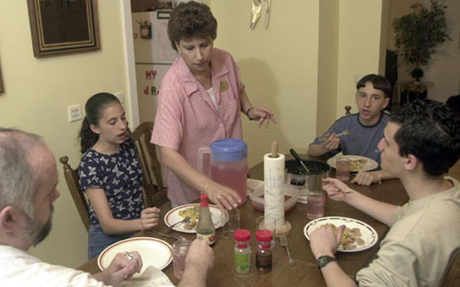 The Rose family, clockwise from left: Jeff, Dahlia, Hilda, Nathanial and Daniel enjoy dinner at their Auerbach, Germany, home in May 2001. Nathanial Rose, who was born in North Carolina and lived at the Camp Lejeune Marine Corps base when the drinking water was contaminated. He links his health problems with the poisoning of the wells there.