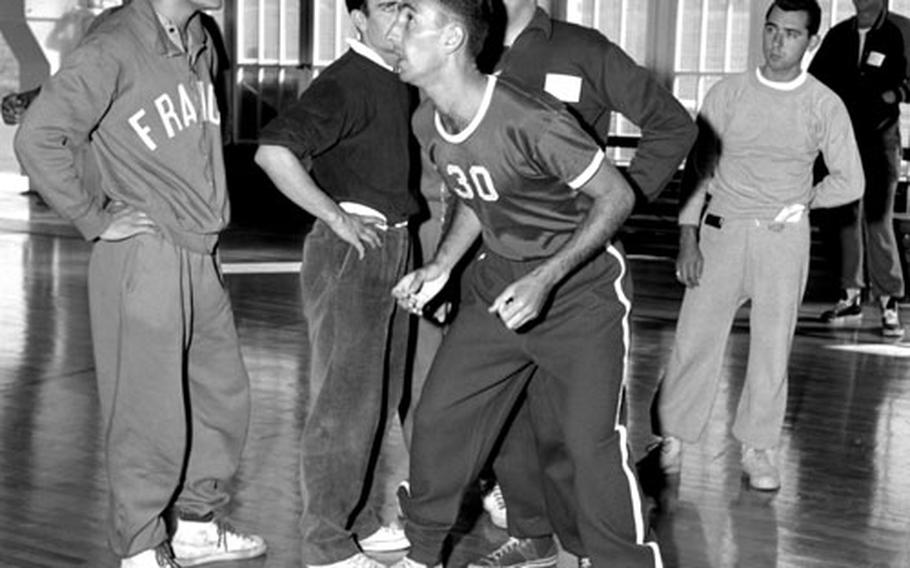 The 1955 USAFE clinic featured instruction by such basketball greats as Bob Cousy (30), Red Auerbach, Adolph Rupp and Auerbach's referee nemesis, Sid Borgia.
