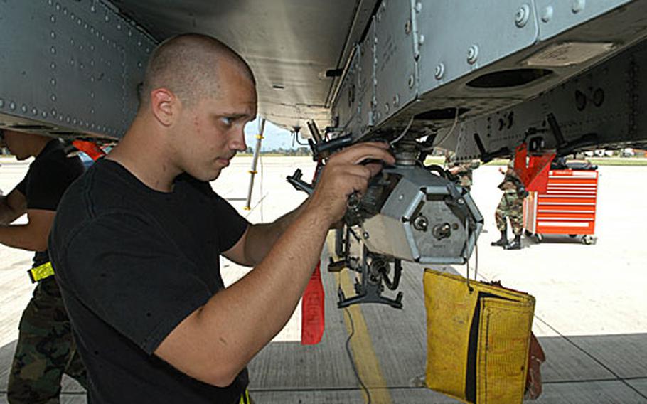 Airman 1st Class Mike Thornell, a weapons load crewmember for the 81st Squadron, inspects the belly of an A-10 jet.