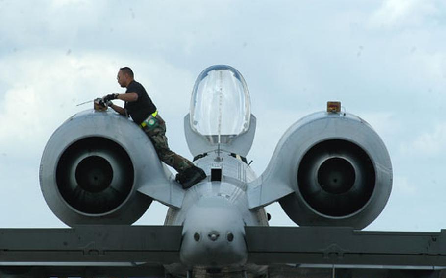 Tech. Sgt. James Pizarro, an A-10 crew chief, inspects the twin engines of the "Warthog" at RAF Lakenheath.