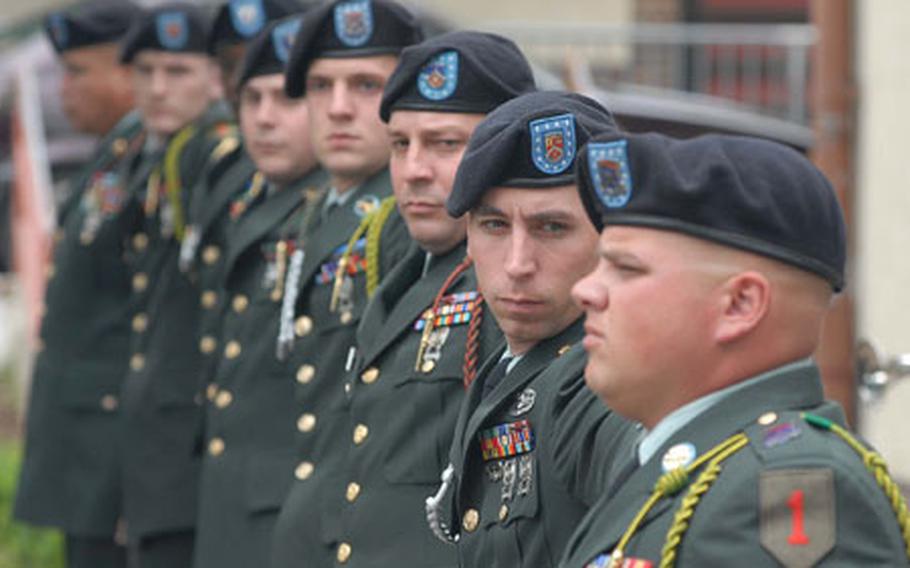 The honor guard "covers down" after lining up to fire volleys in honor of Staff Sgt. Michael Bechert, 1st Battalion, 18th Infantry Regiment, 2nd Brigade Combat Team, 1st Infantry Division, in Schweinfurt, Germany, on Monday.