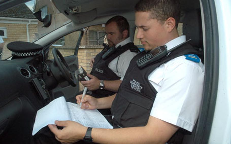Police Community Support Officer Jason Thomas, foreground, and Constable Jono Waller, members of the Lakenheath Safer Neighborhood Team, prepare to roll out on a recent patrol.