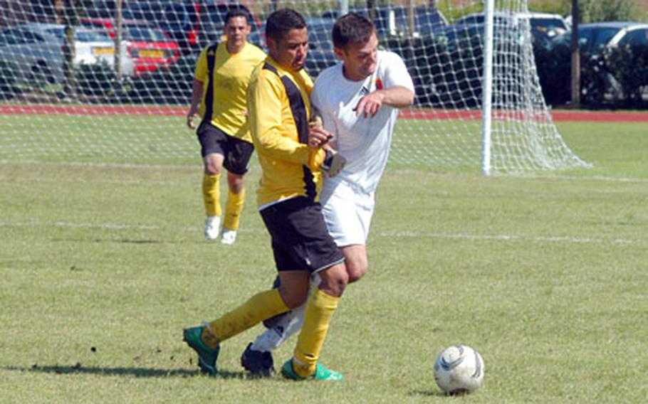 Mildenhall's Matt Shrull (white jersey) collides with Ramstein's Greg Posada as they fight for control of the ball during the men's final.