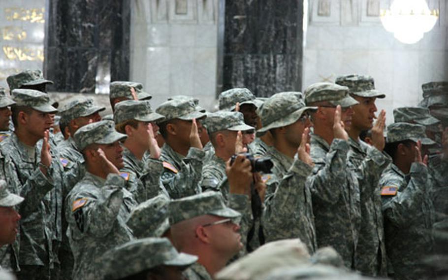 More than 160 servicemen and women from 54 countries became U.S. citizens and more than 500 others reenlisted during the special ceremony, the largest of its kind ever in Iraq.