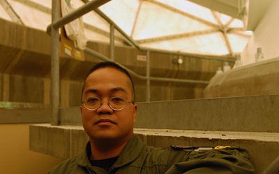 Newly sworn-in commander of Detachment 3 Capt. Florian DeCastro stands under one of the three massive satellite dishes that make up his array at Thule Air Base, Greenland. Housed in the golf ball-esque "radomes," the dishes can locate and connect with various types of satellites, from weather to surveillance, as they come over the top of the planet.