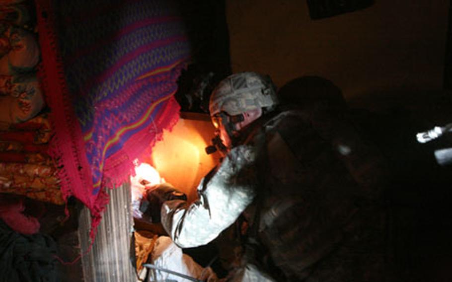 Capt. Eric Melloh, 30, of Huntsville, Texas and commander of Company A, 1-30th Infantry, 2nd Brigade, 3rd Infantry Division, searches the home of a man suspected of helping insurgents direct mortar fire at Forward Operating Base Murray in Iraq’s Arab Jabour district southeast of Baghdad.