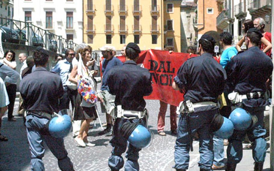 Protesters opposed to the Dal Molin airfield project in Vicenza, Italy, gather outside the provincial headquarters Wednesday as officials talked about the project with the media.