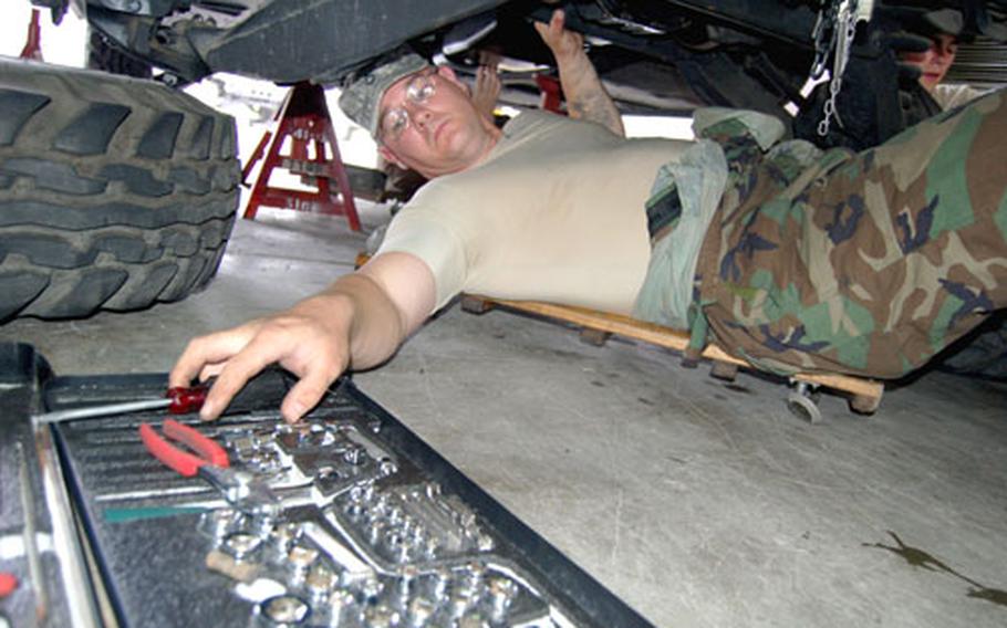 Pfc. David Evans of 201st Signal Company, 1st Signal Brigade, disconnects the brake lines on a Humvee during training Thursday at Camp Coiner, South Korea.