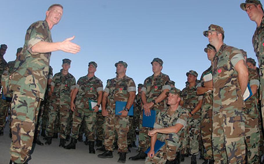 Rear Adm. Joe Leidig, left, deputy commander of U.S. Navy's 6th Fleet, talks Monday with sailors of Sigonella's Explosive Ordnance Disposal Mobile Unit Eight of the Navy's increased importance and commitment to the war on terrorism.
