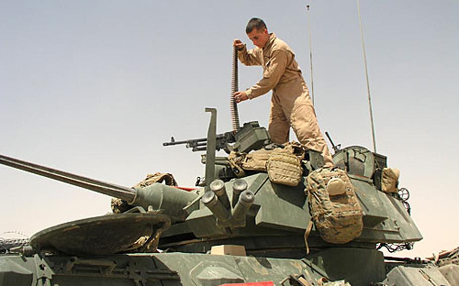 At Combat Outpost Rawah in western Anbar province, Marines of Company C, 1st Light Armored Reconnaissance Battalion readies ammunition before a raid into a remote section of desert.