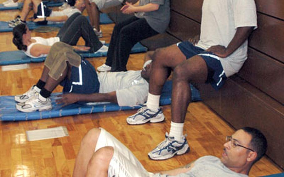 Airmen from 374th Squadron, participate in a circuit class in the Samurai Fitness center.