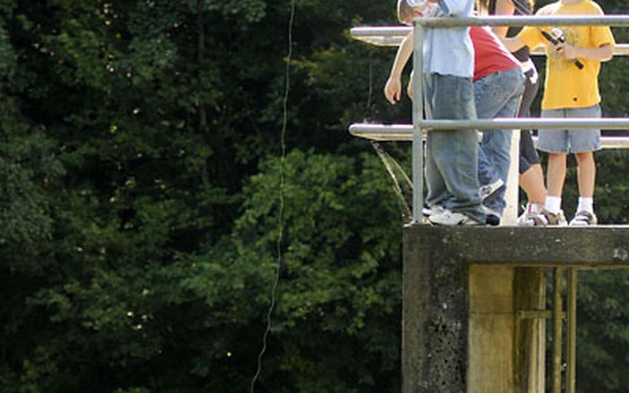 Charles Keller, 9, watches fellow summer camper Alex Marlow, 11, left, send his line soaring during a day out at the Baumholder Outdoor Recreation fishing pond Monday. Individuals or groups can fish for a flat rate of $10 for three fish. The man-made pond is just minutes from Baumholder and is stocked with trout.