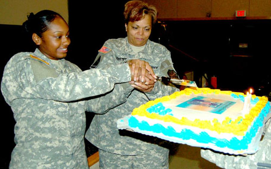 Pvt. Brittny Jackson, left, of 19th Adjutant General Company, and Yongsan Garrison Command Sgt. Maj. Diane Foster participate in a cake-cutting ceremony during the Troop Command Women’s Equality Day observance Monday at Yongsan Garrison.