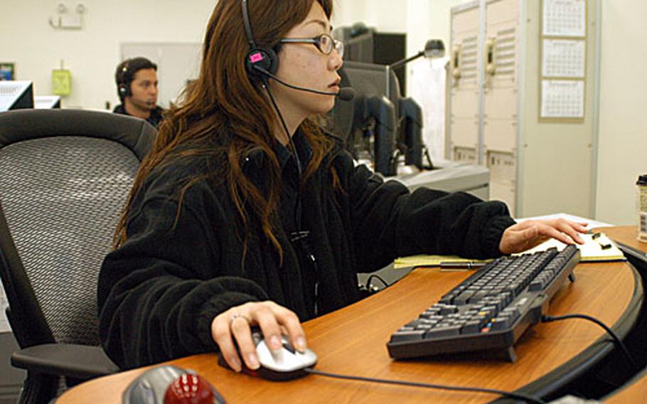 Emergency Services Dispatcher Nariko Niijima works Wednesday in the new Commander, Naval Forces Japan Regional Dispatch Center at Yokosuka Naval Base.
