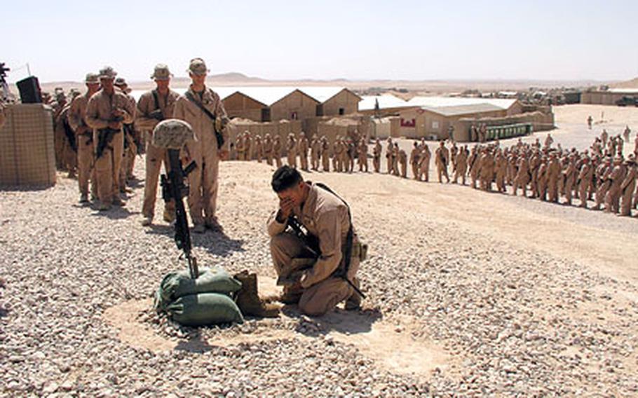 Marines, soldiers and sailors of Task Force Highlander pay tribute to Marine Lance Cpl. Cristian Vasquez, 20, at Combat Outpost Rawah in Iraq. Vasquez was killed Aug. 2 in western Anbar province, Iraq, in a conflict with suspected oil pirates. He was a member of the 1st Light Armored Reconnaissance Battalion, part of Task Force Highlander.