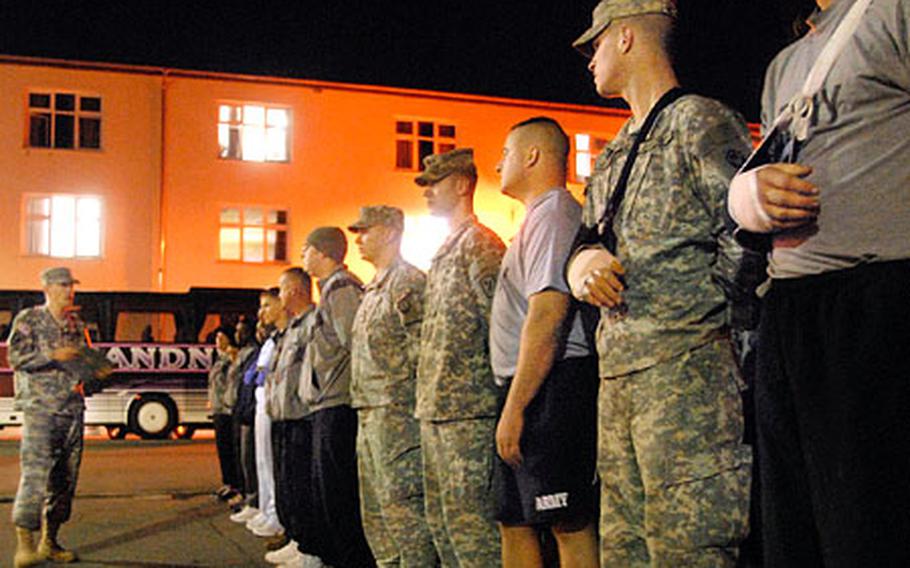 Outpatients from Landstuhl Regional Medical Center wait to hear their appointment times while standing in formation at Kleber Kaserne in Kaiserslautern, Germany, in March.