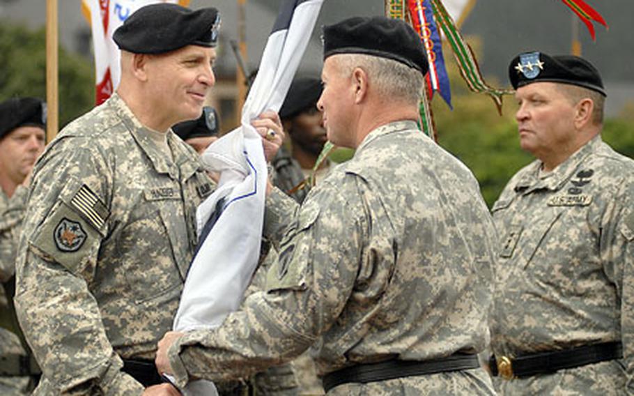 Lt. Gen. Kenneth Hunzeker, accepts command of V Corps as Gen. David McKiernan, the commanding general of U.S. Army Europe and 7th Army, passes the guidon during a change of command ceremony Wednesday at Campbell Barracks in Heidelberg. Lt. Gen. James Thurman, the outgoing commander of V Corps is moving to the Pentagon and will serve as the director for Operations and Plans (G3) for the Chief of Staff of the Army.