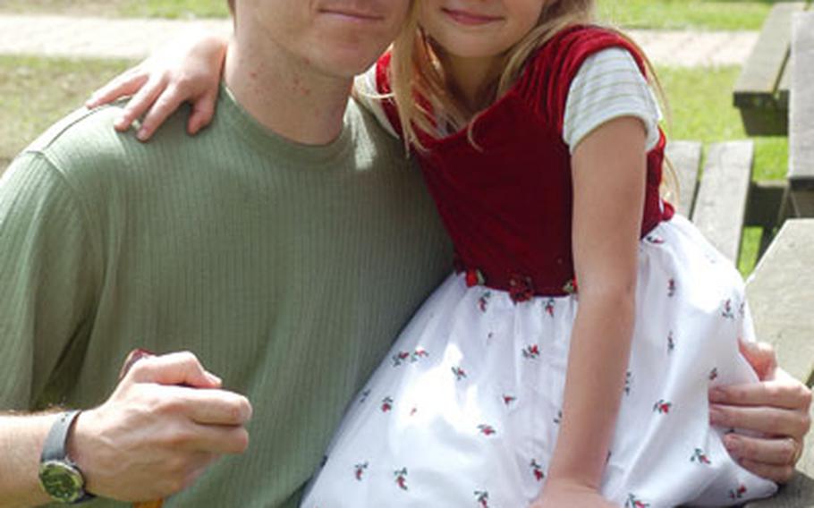 Sgt. Archie Hennessey, with his daughter, Summer, says he feels betrayed that the Army classified him as only 10 percent disabled after an on-duty back injury left him unable to walk without a cane, in frequent pain and wondering what his post-Army future will hold.