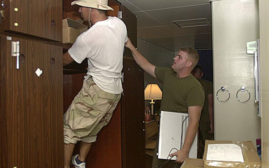 At right, Lance Cpl. Brandon Pullen, 22, from Custer, Ky., with Motor Transport Company, Combat Logistics Readiness Battalion 4, oversees movers as they pack up his belongings to be placed in storage while Pullen is deployed to Iraq. The battalion is heading to Anbar province over the next few days for a six- to seven-month deployment.