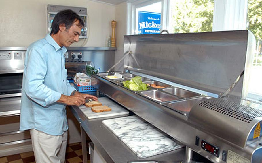 Malcolm Thompson, owner of Mickey's restaurant on RAF Mildenhall, prepares a sandwich last week. The restaurant has been around for more than 50 years, surviving financial setbacks as a result of gate closures following the Sept. 11 attacks.