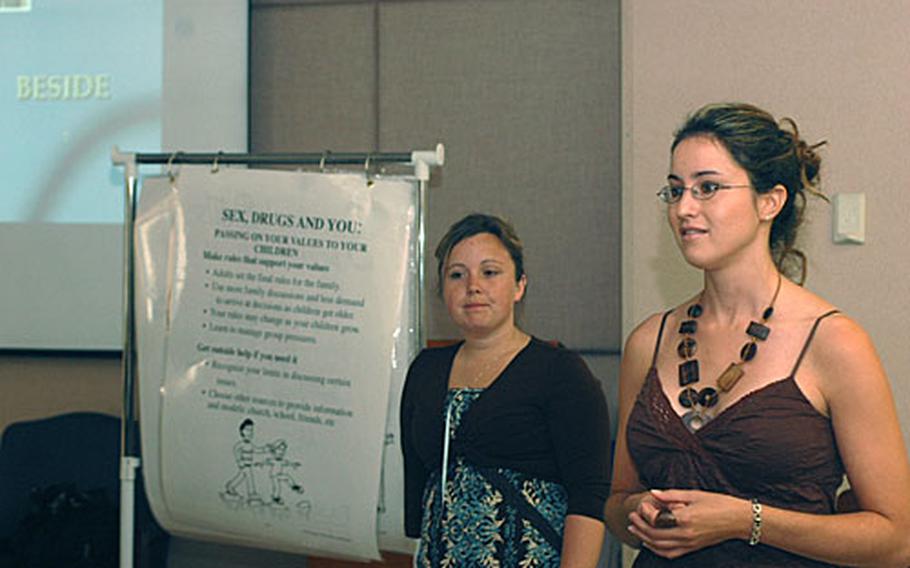 Jessica Wood, right, and Amy Jensen, both working toward master's degrees in counseling, role play Tuesday in leading a family wellness retreat. The women traveled from Ramstein Air Base in Germany to Naples, Italy, to take the course that will help them in their counseling careers, and certify them to eventually teach other counselors to lead the retreat sessions.