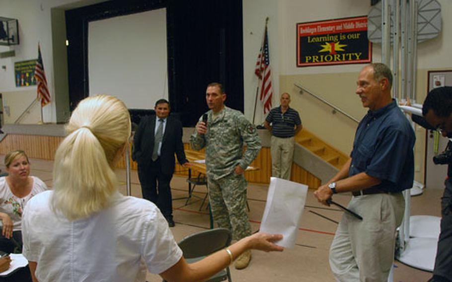 Col. Richard M. Pastore Jr., center, commander of Army Garrison Stuttgart, listens as a parent complains about the school rezoning plan unveiled during a town-hall meeting in Boeblingen.