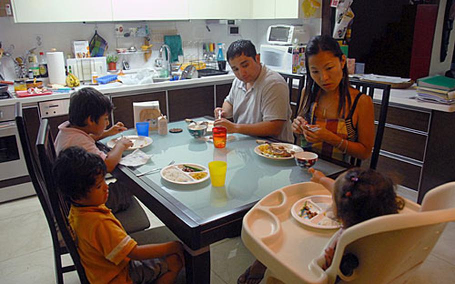 Jeff and Ko Waye, who married while Jeff was in the U.S. Army, eat dinner with their family. Clockwise is their daughter Jun, 2, son Riku, 4, and son Hiro, 6. Jeff is American and Ko is Japanese.