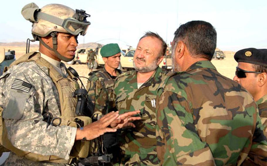 U.S. and Afghan troops discuss what is going to happen on this mission in the town of Shewan, Farah province, Afghanistan.