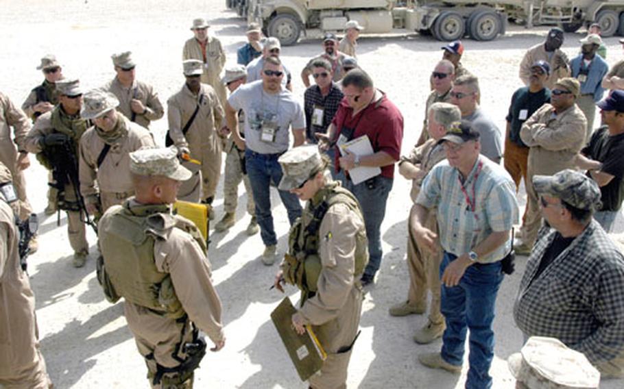 Contractors with Kellogg, Brown and Root gather with Marines from 2nd Platoon, Transportation Support Company, Combat Logistics Battalion 2 for a debriefing before returning to Al Asad Air Base from a supply run earlier this year.