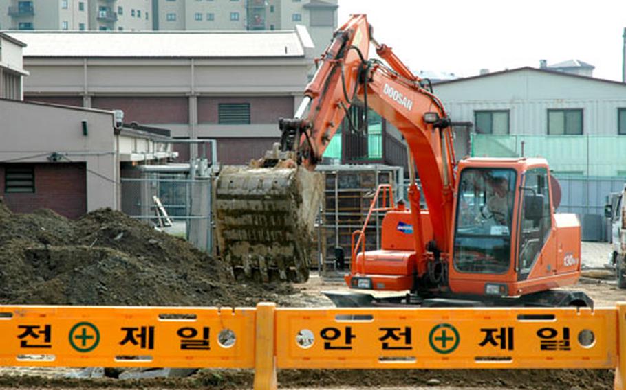 Construction crews work to clear a plot for an expanded part of the high school at Osan Air Base last week. The expansion will be two stories and will house eight classrooms. It’s part of a $20.7 million project that also will include a new middle school and a three-story parking structure.