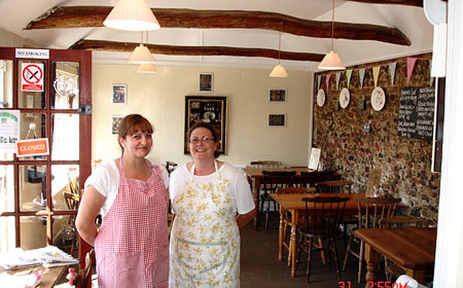 Lizzy&#39;s Cafe owner Liz Mason, left, and waitress Annette Sutton pose in the sunlit cafe.