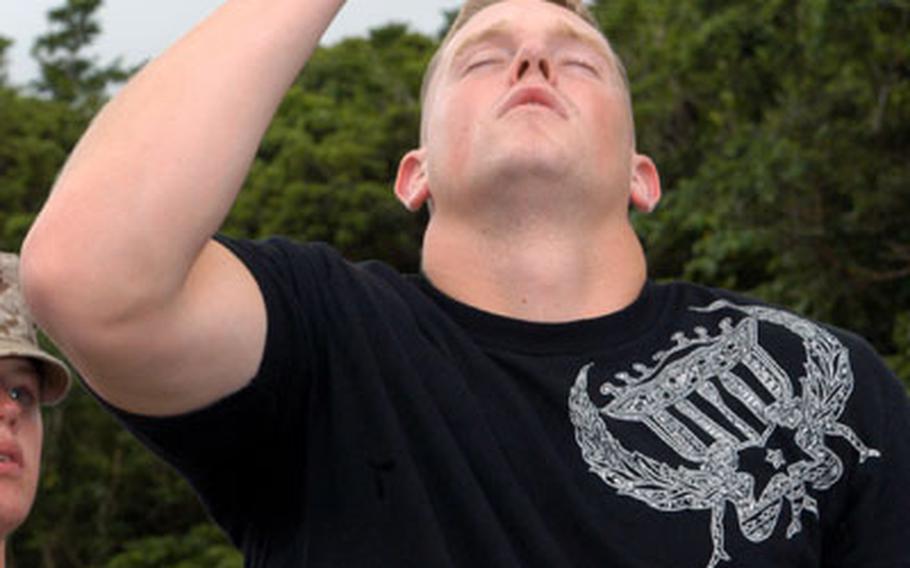 Marine Cpl. Kyle Thompson, 21, touches his finger to his nose during a field sobriety test Tuesday. Thompson was one of four Marines who consumed alcohol in a controlled setting to give military police at Camp Foster, Okinawa, practice detecting the effects of alcohol on driving.
