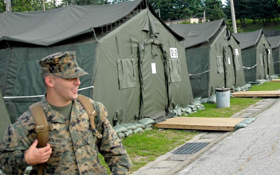 Sgt. Chris Hoagland of North Carolina talks outside his tent Monday at U.S. Army Garrison Yongsan’s Camp Coiner. The tent city is one of several life support areas set up at U.S. Forces Korea installations to house visiting troops during the Ulchi Focus Lens annual training exercise.
