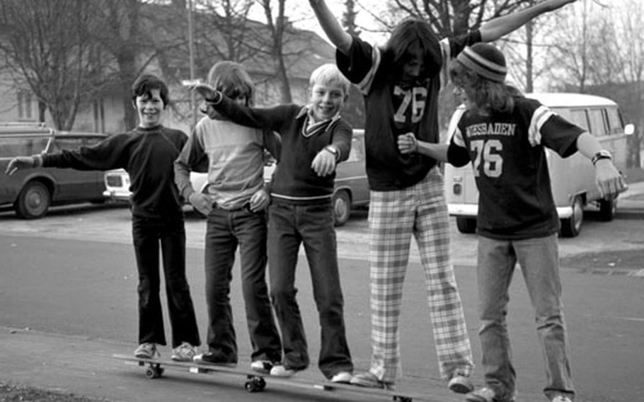 Five Wiesbaden youngsters have to do a delicate balancing act just to stay aboard an eight-foot-long skateboard built by Dean Carter and Brian Larrimer. Maneuvering the monster are, from left, Ken Reid, Bruno Crossill, Henry Zorn, and builders Carter and Larrimer.